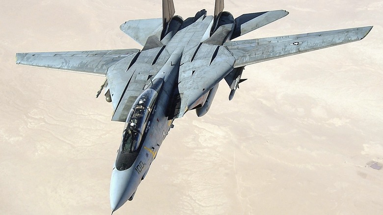 F-14D on patrol above a desert in the Middle East seen from above and slightly to the left