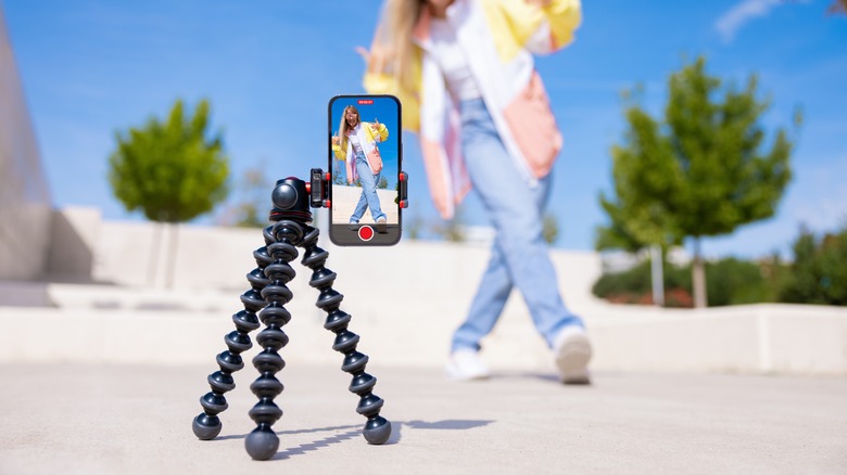 Person recording themselves dancing with smartphone