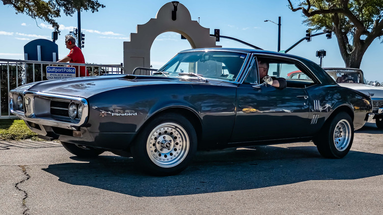 1967 Pontiac Firebird leaving parking lot
