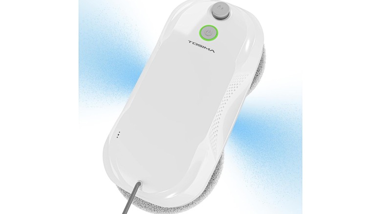 White robotic device with two round scrubber heads on a window