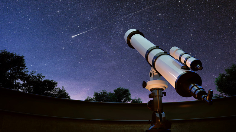 A white telescope aiming at the stars