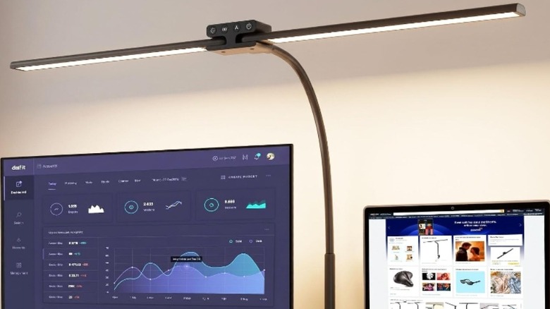 EppieBasic LED Desk Lamp illuminating two computer screens. Note the pivot in the middle of the unit.