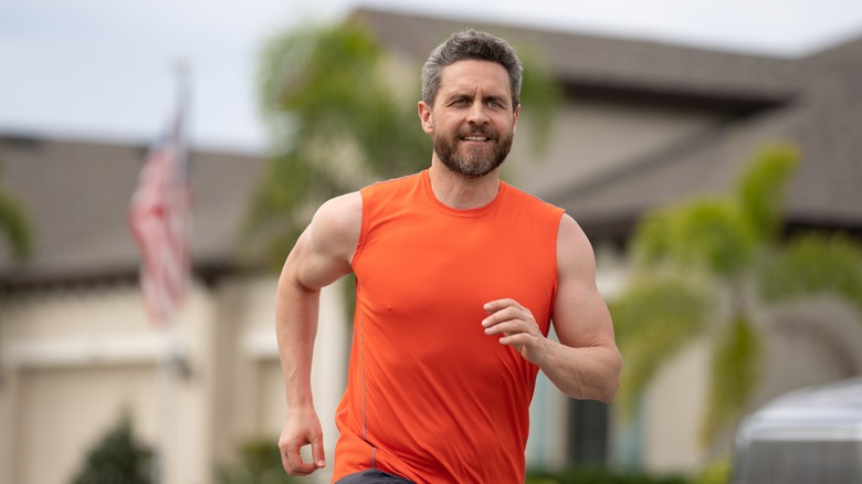 man running outside on road