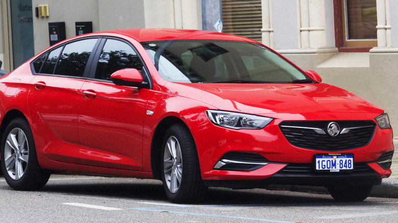 Red Holden Commodore seen from right front