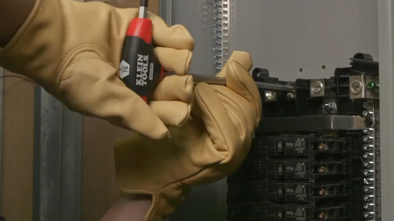 Focus on a worker as they use one of Klein Tools hex keys to turn a bolt.