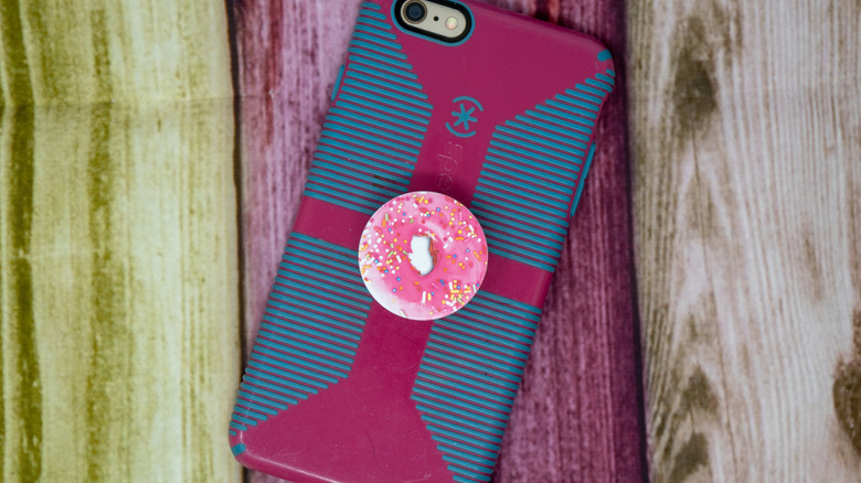 pink donut popsocket on back of phone
