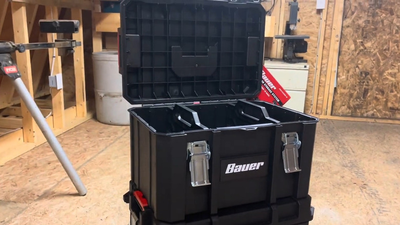 Open tool box in a plywood room