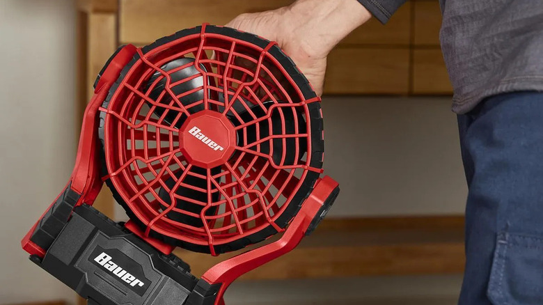 Man holding a Bauer 120V/20V fan