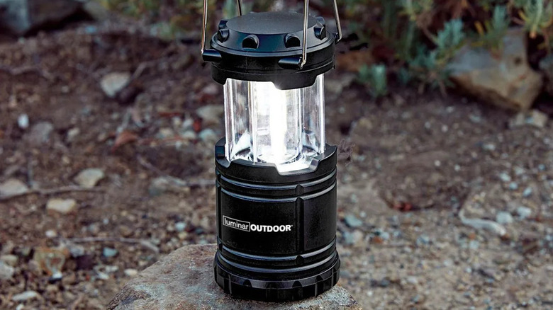 Luminar pop-up lantern outside, resting on rocky ground