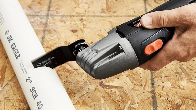 Warrior oscillating multi-tool cutting plastic pipe.