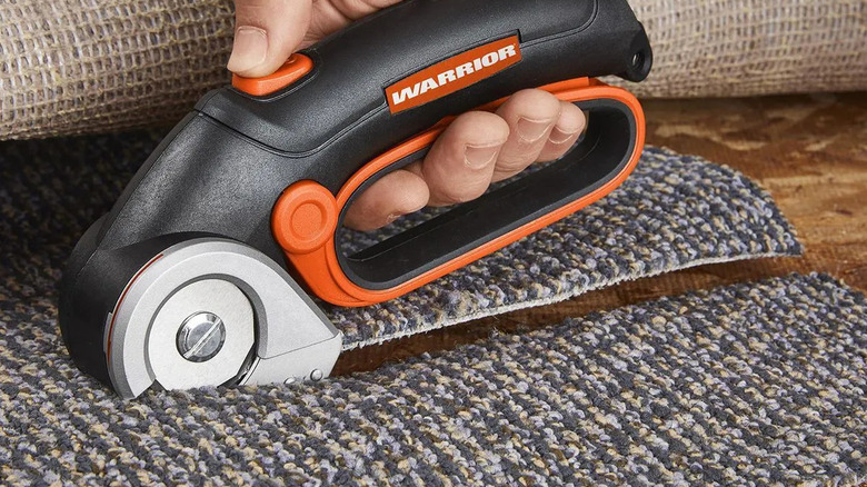 Cutting carpet with a Warrior power cutter.