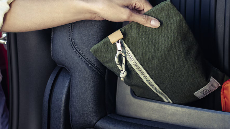 Placing a pouch in the storage of a leather seat