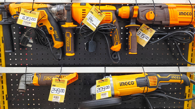 Various orange tools branded Ingco on a tool rack. Each ahs a price tag.