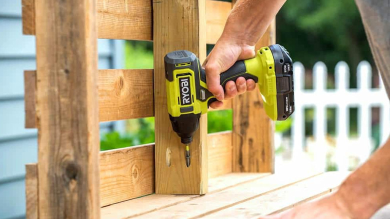 A Ryobi drill/driver used to drive a screw.