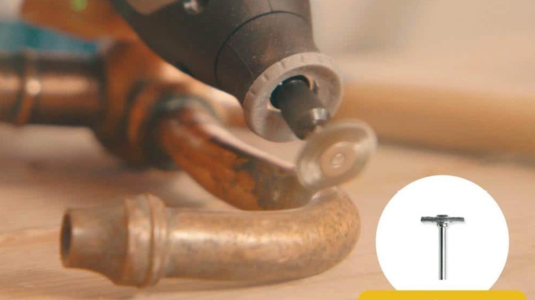 A rotary tool being used to cut a pipe.