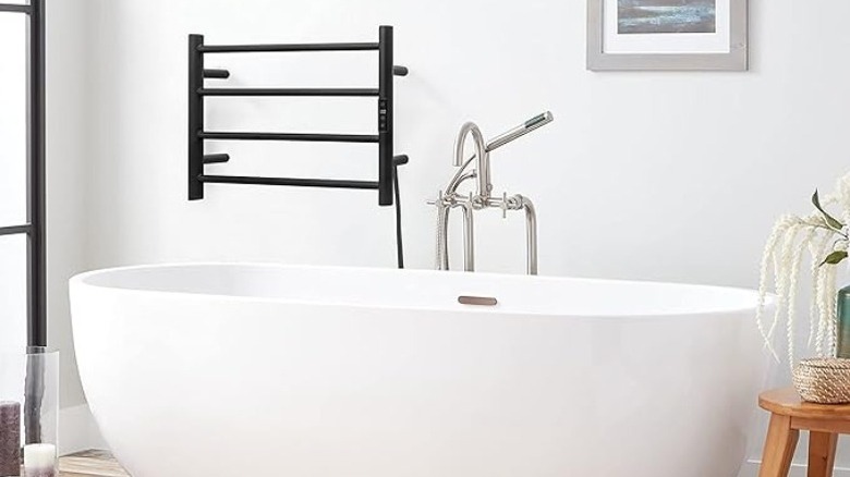 Bathtub with a multi-bar towel rack above it