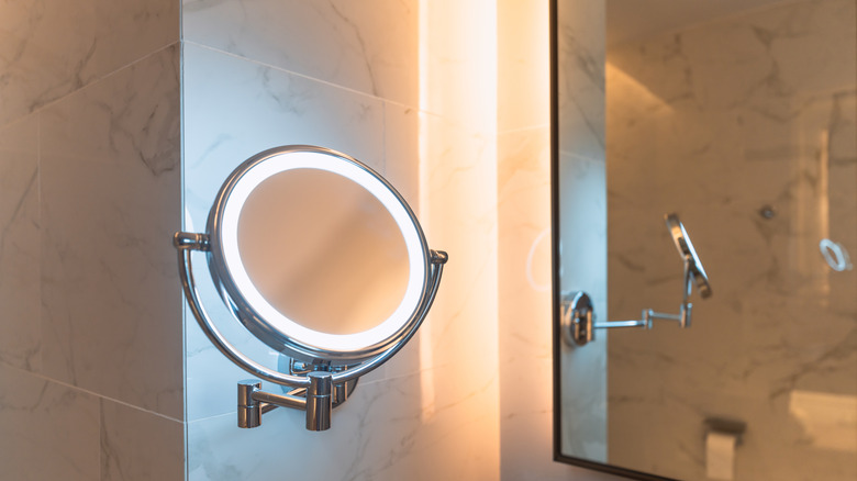 Lighted mirror mounted on a tile wall