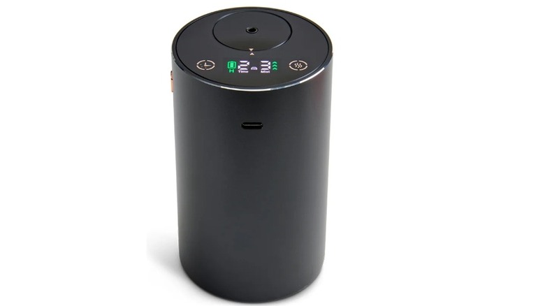 Black cylindrical device with a hole on the top