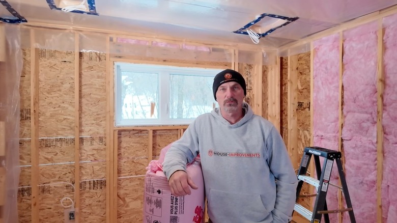 Shannon from HouseImprovements installing installation in a wall