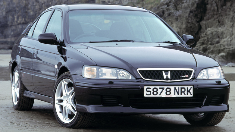 A Honda car's front grille featuring the iconic 'H' emblem in chrome