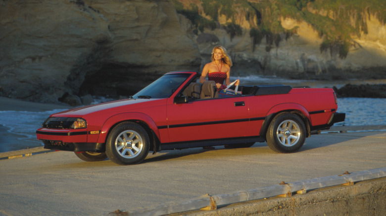 A red Toyota Celica GTS Convertible version seen parkd next to a hill