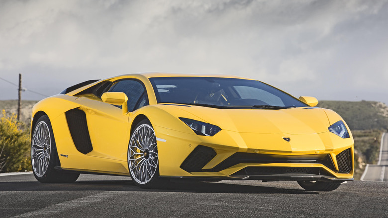 Yellow Lamborghini Aventador S parked on a road