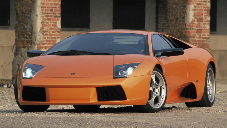 Orange Lamborghini Murciélago parked in front of a building