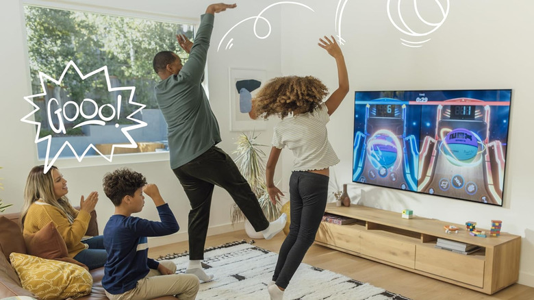 Kids playing an activity-based video game with family