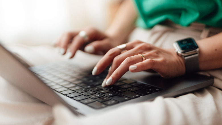 A person typing on a laptop