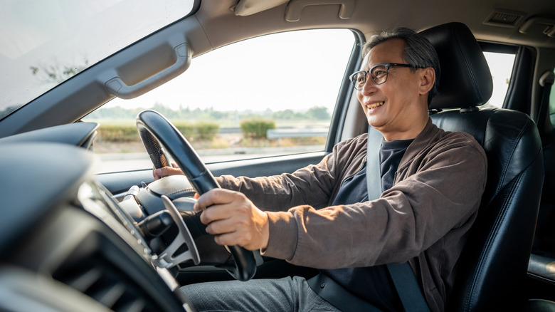 Older man driving car