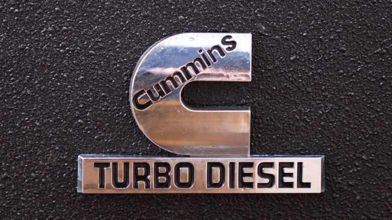 A metallic Cummins Turbo Diesel emblem on a textured black surface.