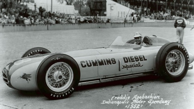 Freddie Agabashian sitting in the 1952 Cummins Diesel Special race car at the Indianapolis Motor Speedway.