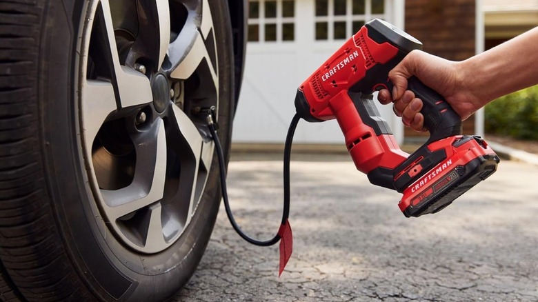 man using Craftsman Air Inflator on car tire