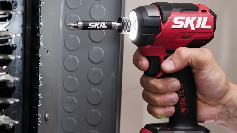 man using light on Skil PWR Core 12 Drill Driver