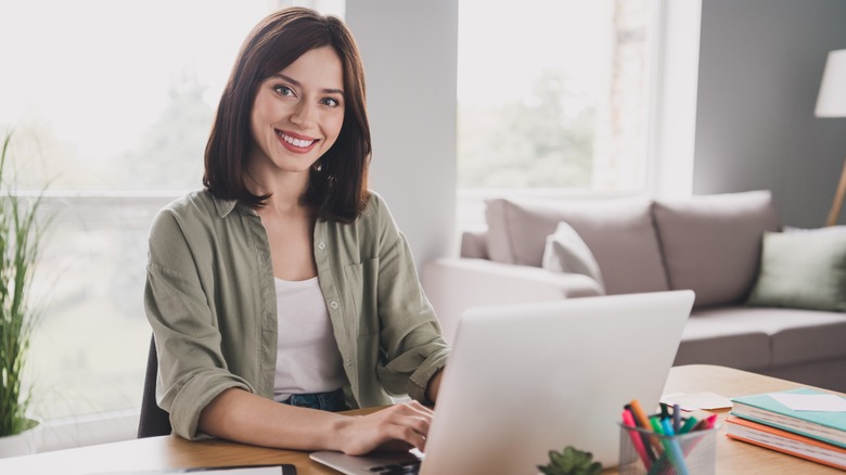 woman writing on macbook