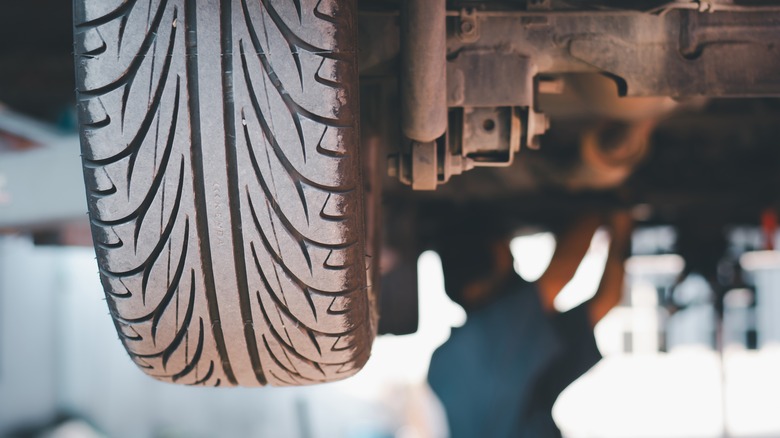 mechanic working under lifted car