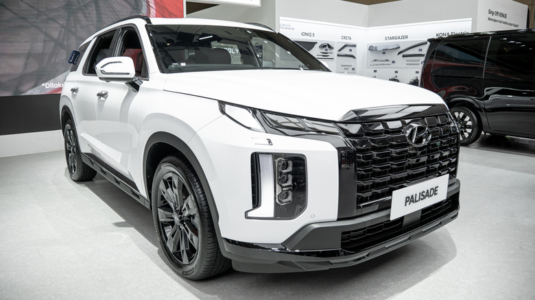 A white Hyundai Palisade on display in showroom