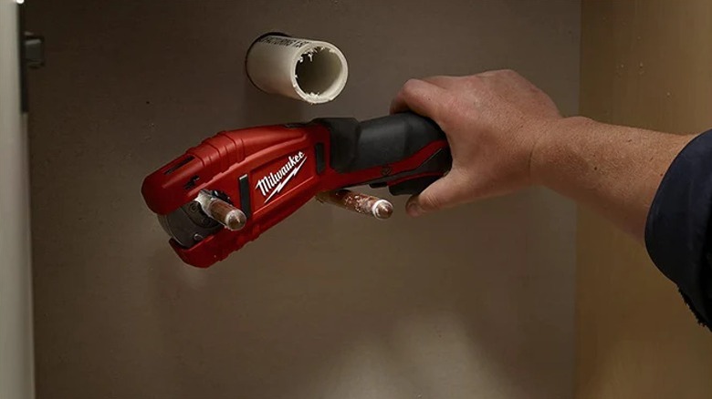 Using copper tubing cutter on a rusty surface.