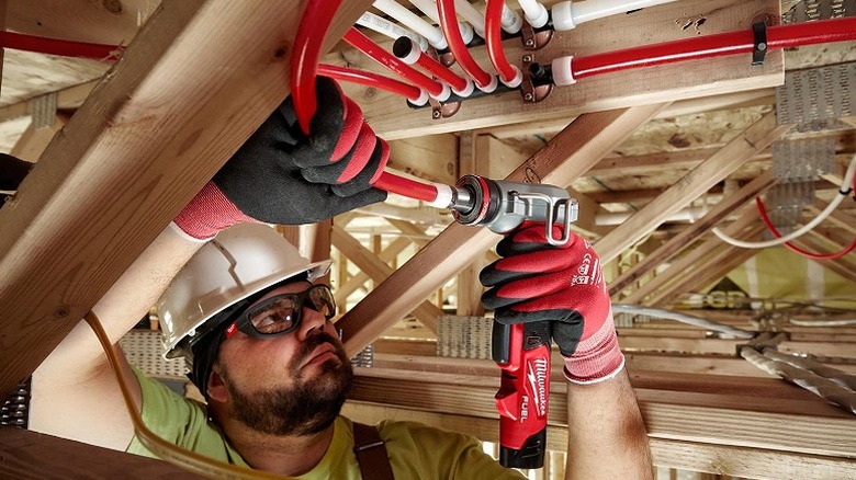 Man working on a ceiling project with ProPex Expander.