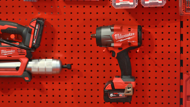 A Milwaukee power impact wrench surrounded by other Milwaukee tools.