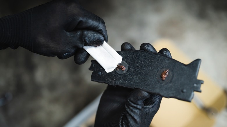 lubricating the back of a brake pad