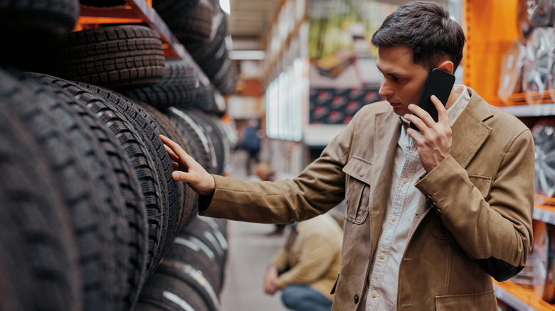 Man looking at new tires