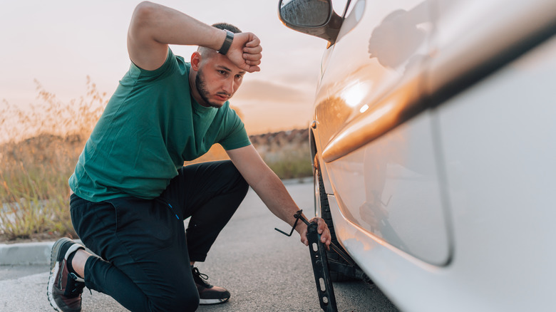 Man changing car tire