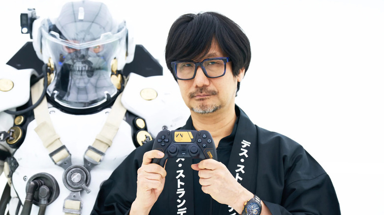 Hideo Kojima holding the special Death Stranding DualSense controller