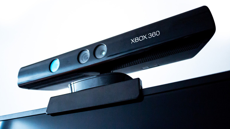 The Xbox 360 Kinect motion sensor placed on top of a TV against a white background