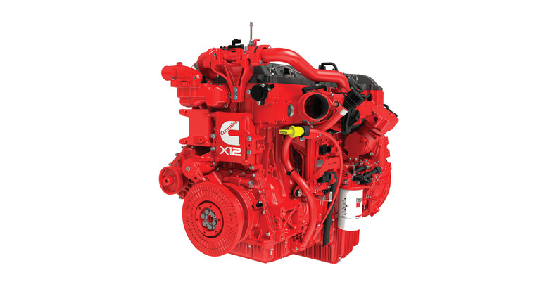 A fire-engine red X-12 engine from Cummins, side view seen