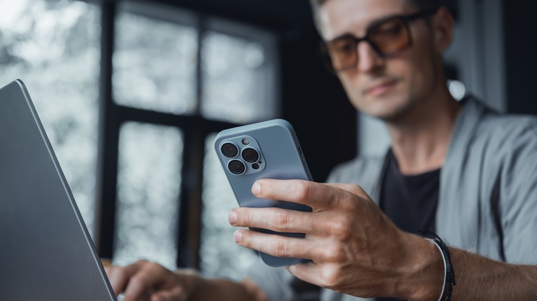 man using iphone one-handed