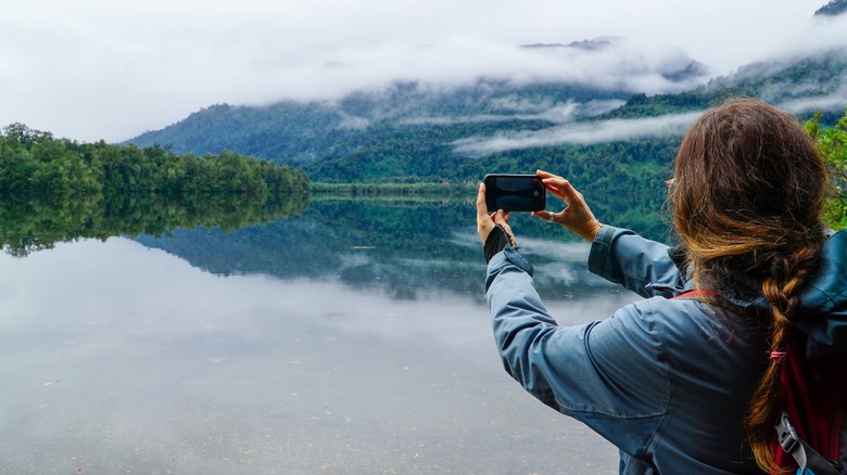 woman taking landscape picture
