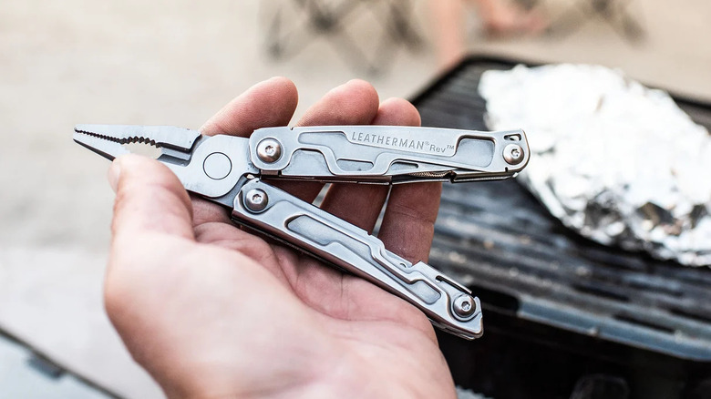 The Leatherman Rev multitool being held in someone's hand