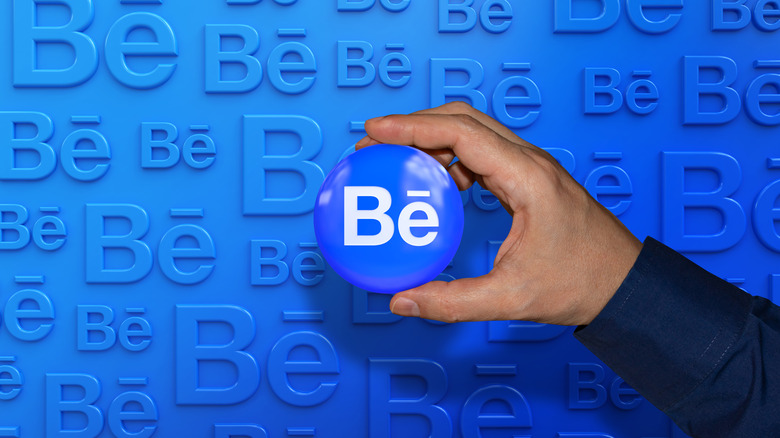hand holding Behance logo in blue circle